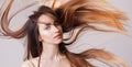 Beautiful model girl with shiny flying brown ombre straight long hair . Care and hair products . Royalty Free Stock Photo