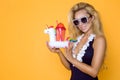 Beautiful model in a bikini and sunglasses, holding a drink and an inflatable unicorn. Royalty Free Stock Photo