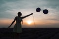 A beautiful model with long braids stands in a lavender field. Holds two balloons in his hands. Silhouette photo. Sunset in the Royalty Free Stock Photo