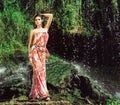 Beautiful model posing in front of a waterfall Royalty Free Stock Photo