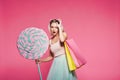 Beautiful model with sweets at pink background