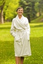 A beautiful model wearing a white toweling robe standing Royalty Free Stock Photo