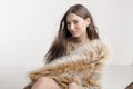 Beautiful model woman girl brunette in a fur coat