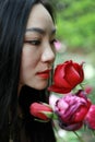 Beautiful model woman kissing red rose flower Royalty Free Stock Photo