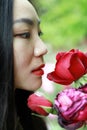 Beautiful model woman kissing red rose flower Royalty Free Stock Photo