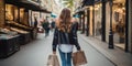 A beautiful model woman walking with shopping bags buying clothes in stores on a paris street in france. fashionable lady with Royalty Free Stock Photo