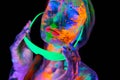 Beautiful model woman wearing glasses with colorful bright fluorescent makeup in neon light, nightclub disco Royalty Free Stock Photo