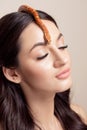 Beautiful model young brunette woman with snakes on her hair a symbol of skin elasticity, facelift, long eyelashes and