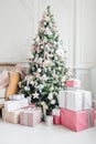 Beautiful modern design of the room in delicate light colors decorated with Christmas tree and decorative elements Royalty Free Stock Photo