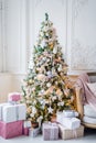 Beautiful modern design of the room in delicate light colors decorated with Christmas tree and decorative elements Royalty Free Stock Photo