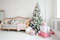 Beautiful modern design of the room in delicate light colors decorated with Christmas tree and decorative elements Royalty Free Stock Photo