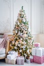 Beautiful modern design of the room in delicate light colors decorated with Christmas tree and decorative elements Royalty Free Stock Photo