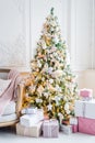 Beautiful modern design of the room in delicate light colors decorated with Christmas tree and decorative elements Royalty Free Stock Photo