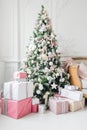 Beautiful modern design of the room in delicate light colors decorated with Christmas tree and decorative elements Royalty Free Stock Photo