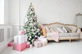 Beautiful modern design of the room in delicate light colors decorated with Christmas tree and decorative elements Royalty Free Stock Photo