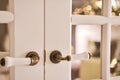 Beautiful modern door knob. Christmas lights on the background. Open, wooden front door from the interior of an upscale Royalty Free Stock Photo