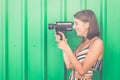 Beautiful modern girl with old 8mm camera. Royalty Free Stock Photo