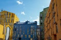 Beautiful modern houses painted in bright colors.Beautiful blue sky and clouds.Auto-watering system and rainbow in jets of water Royalty Free Stock Photo