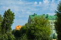 Beautiful modern houses painted in bright colors.Beautiful blue sky and clouds.Auto-watering system and rainbow in jets of water Royalty Free Stock Photo