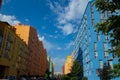 Beautiful modern houses painted in bright colors.Beautiful blue sky and clouds.Auto-watering system and rainbow in jets of water Royalty Free Stock Photo