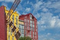 Beautiful modern houses painted in bright colors.Beautiful blue sky and clouds.Auto-watering system and rainbow in jets of water Royalty Free Stock Photo