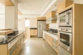 Beautiful modern kitchen with black granite counter tops,large tiled floors and oak doors Royalty Free Stock Photo