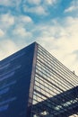 A beautiful, modern, mirrored building. The view from below. Sky with clouds. Corporate building. Royalty Free Stock Photo