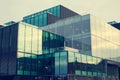 A beautiful, modern, mirrored building. The view from below. Sky with clouds. Corporate building. Royalty Free Stock Photo