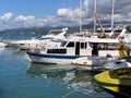 Beautiful modern motor yachts stand on the pier on the waterfront