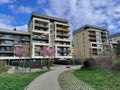 Beautiful modern residential houses with large balconies and nicely styled park in the foreground