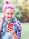 Beautiful modern smiling young female teenager Portrait with extraordinary hairstyle color in a checkered shirt chuting via