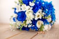 Beautiful modern wedding bouquet of blue chrysanthemum, freesia, roses and peony. on wooden background. With rings newlyweds Royalty Free Stock Photo