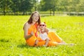 Beautiful Mom and baby outdoors. Happy family playing in nature. Royalty Free Stock Photo