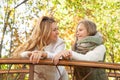 Beautiful mom and daughter in autumn forest