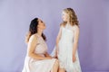 Beautiful mom and daughter in white dresses in close family