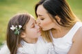 Beautiful mom kissing her little daughter on the nose Royalty Free Stock Photo