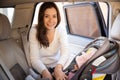 Beautiful mom putting baby on a child seat Royalty Free Stock Photo