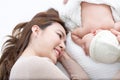 Mother with infant baby on white bed Royalty Free Stock Photo