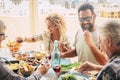 Beautiful moment of family lifestyle at home eating and drinkng food or drinks at home on the table - man with sunglasses tking a