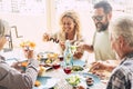 Beautiful moment of family lifestyle at home eating and drinkng food or drinks at home on the table - man with sunglasses tking a