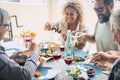 Beautiful moment of family lifestyle at home eating and drinkng food or drinks at home on the table - man with sunglasses tking a