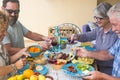 Beautiful moment of family lifestyle at home eating and drinkng food or drinks at home on the table - man with sunglasses tking a