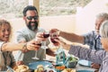 Beautiful moment of family lifestyle at home eating and drinkng food or drinks at home on the table - man with sunglasses tking a