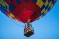 A colorful hot air balloon on a beautiful summerday with a blue sky.