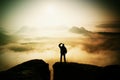 Beautiful moment the miracle of nature. Man stands on the peak of sandstone rock in national park Saxony Switzerland and watching