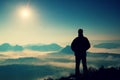 Beautiful moment the miracle of nature. Man stands on the peak of sandstone rock in national park Saxony Switzerland and watching Royalty Free Stock Photo