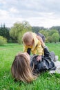 A beautiful moment of mother lifting son up in a spring park. Royalty Free Stock Photo