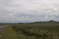 Beautiful mongolian landscape. Road at the left side, with only one car. Royalty Free Stock Photo