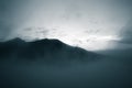 A beautiful monochromatic mountain view with rising clouds Royalty Free Stock Photo