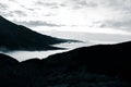 A beautiful monochromatic mountain view with rising clouds Royalty Free Stock Photo